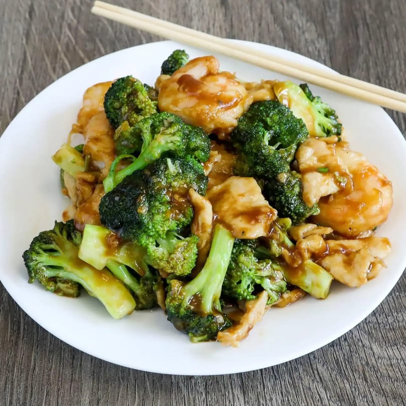 Linsway Grill & Teriyaki's chicken and broccoli stir-fry with a rich sauce, served with chopsticks.